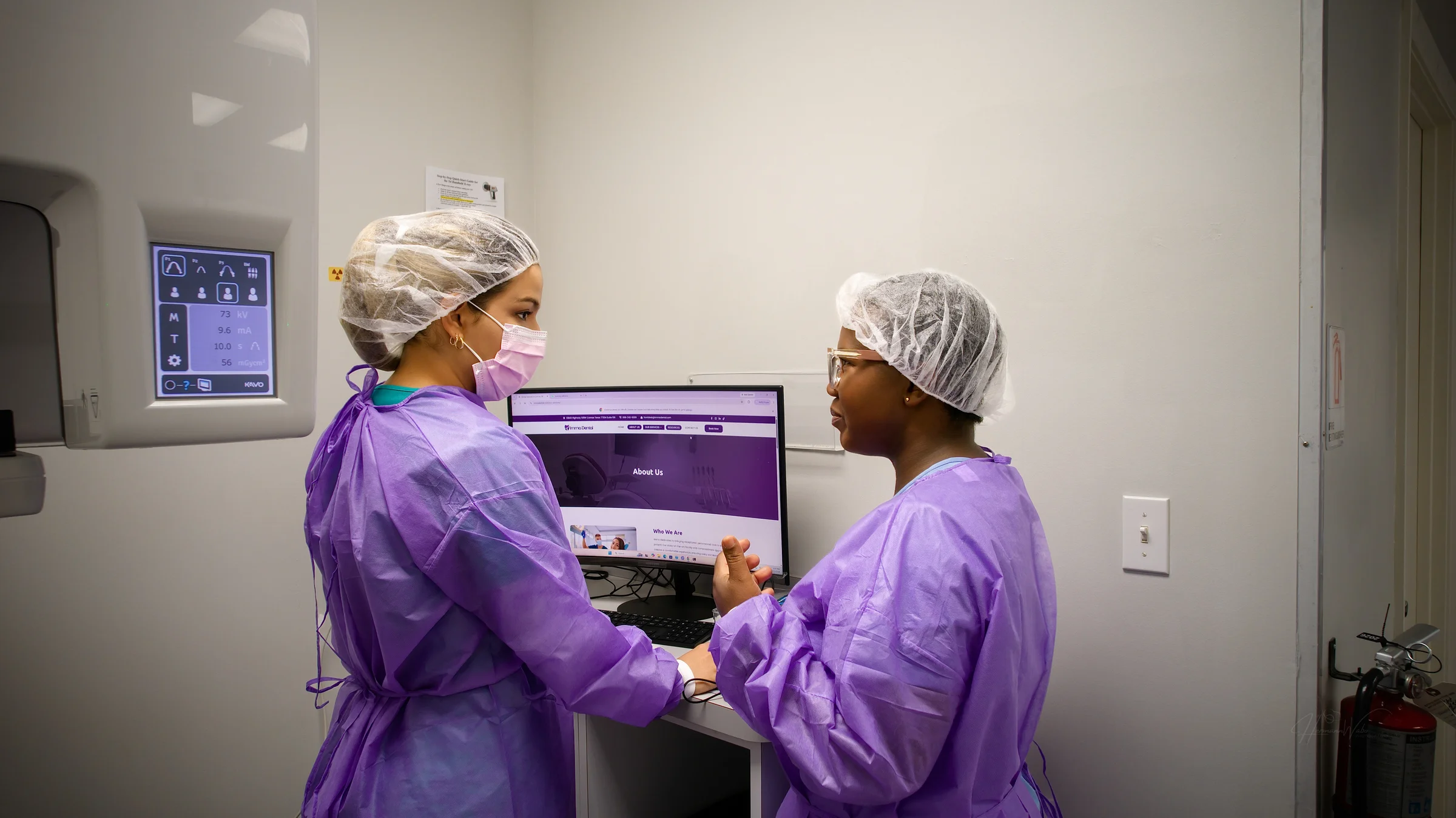 Two Imma Dental team members reviewing a workstation