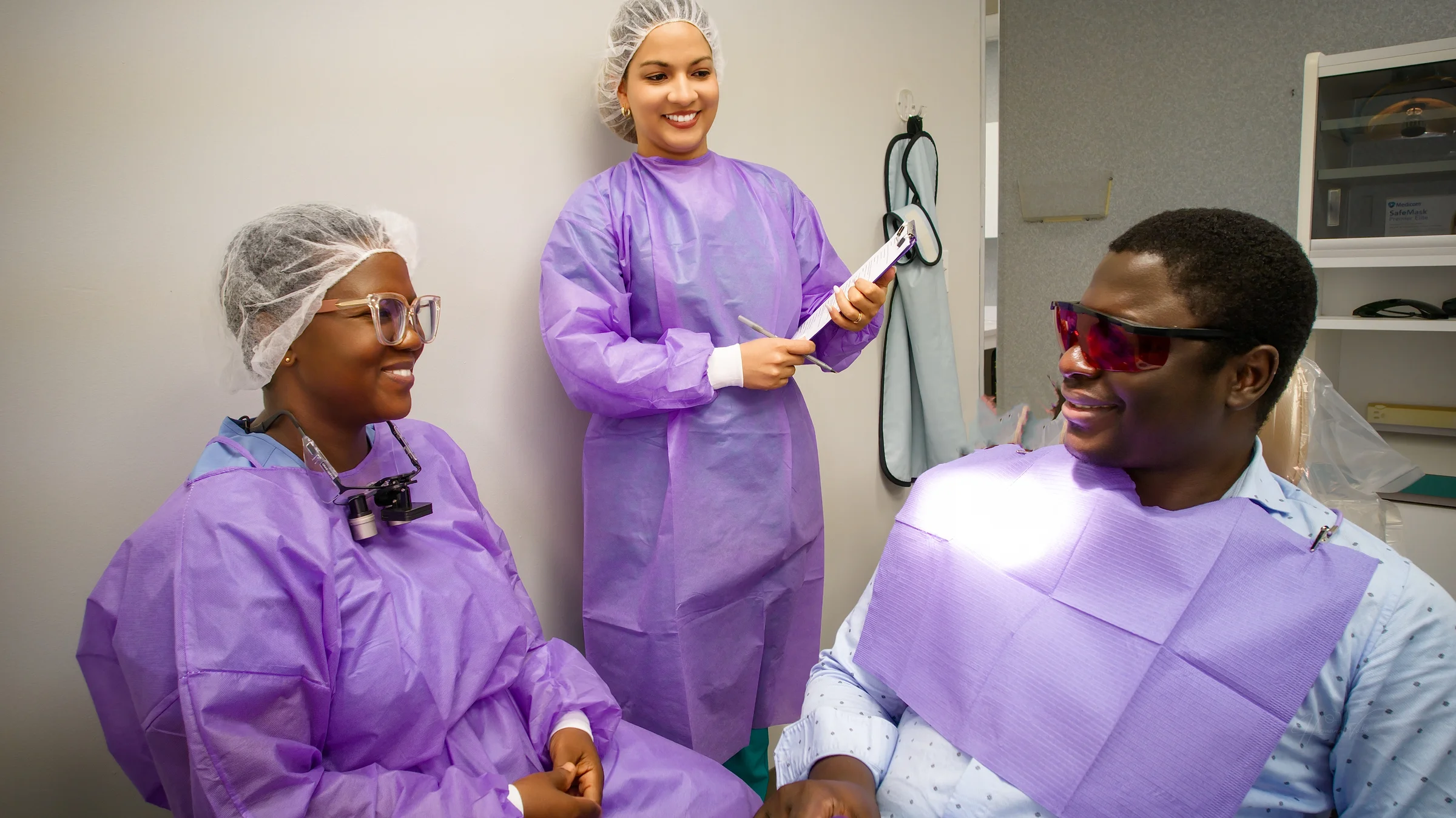 The Imma Dental team with a patient in a treatment room