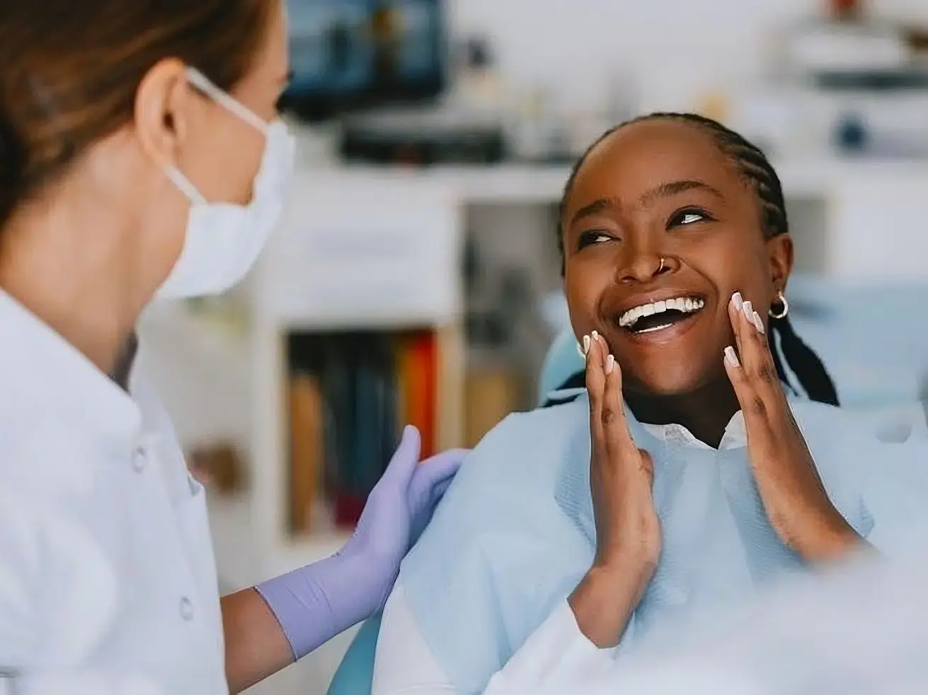 A smiling patient speaking with a dental professional